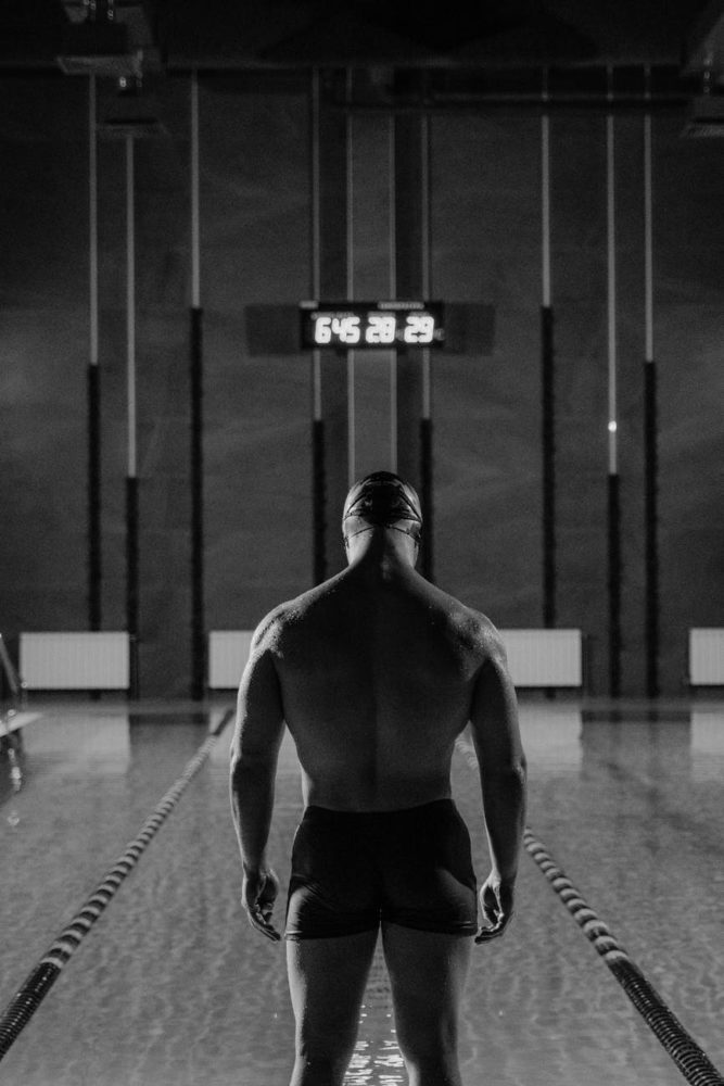 man in black trunks ready to dive